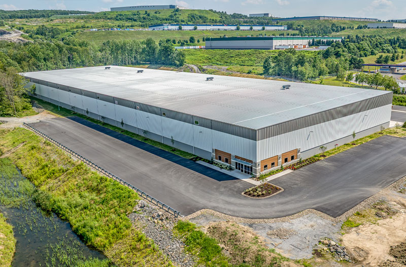 Aerial view of 525 Research Drive, a newly constructed industrial facility in CenterPoint Commerce & Trade Park, Jenkins Township, PA, surrounded by green landscape and nearby distribution centers.